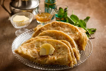 Fototapeten traditional morocco bread wih butter honey and mint tea © Marco Mayer