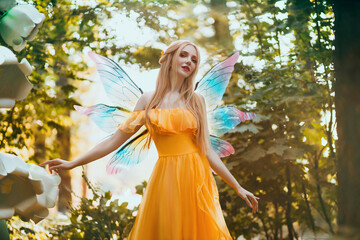 Portrait fantasy woman blonde forest fairy. Elf girl fashion model in bright yellow dress,...