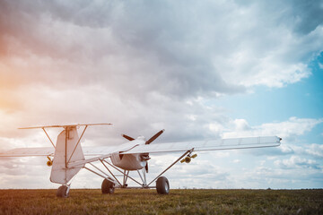remote controlled agriculture spaying air plane in field at sunset, no people