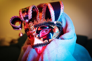 Young woman in a carnival mask.