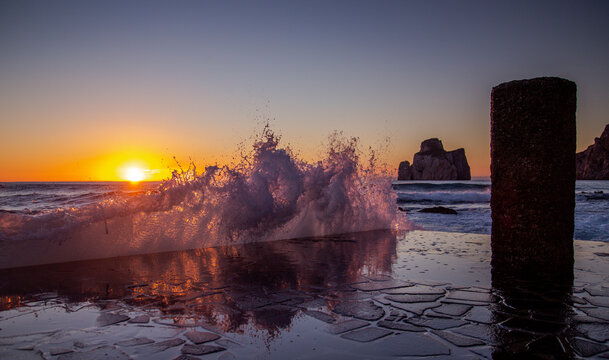 super sunset in the south of sardinia in front of the stack of sugar loaf, masua, iglesias
