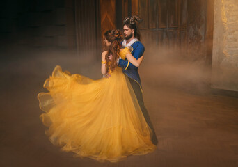 couple is dancing at fantasy ball. Happy beauty woman princess in yellow dress and guy enchanted...