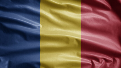 Romanian flag waving in the wind. Close up of Romania banner blowing soft silk.