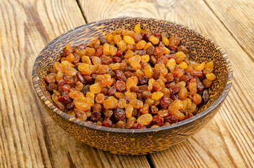 Dried grapes, raisins in wooden bowl. Studio Photo