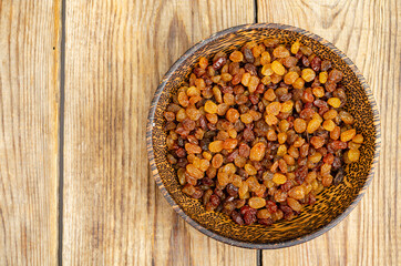 Dried grapes, raisins in wooden bowl. Studio Photo