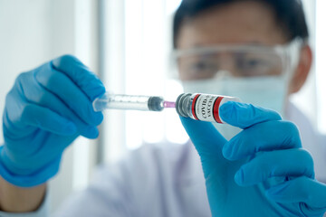 Doctors or scientist are preparing the anti covid-19 vaccine with syringe