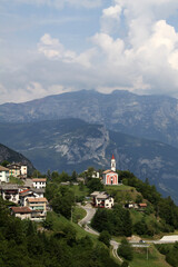 Mountain landscape with the town of Guardia and its small church, Trentino, Italy