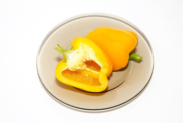Yellow pepper paprika on plate on white background