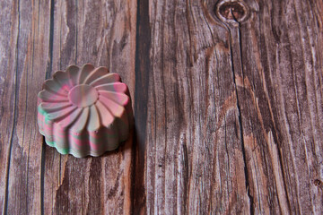 Bright organic hand-made scented soap in the shape of a flower .