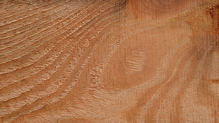 Wood texture background. Wood plank texture with vertical curved lines. Wooden board with a wavy surface, close-up.