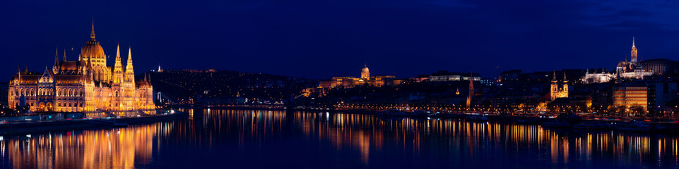 Fototapeta na wymiar Night Budapest, Parliament against the background of the night city, reflection of lights in the river, panorama of the city