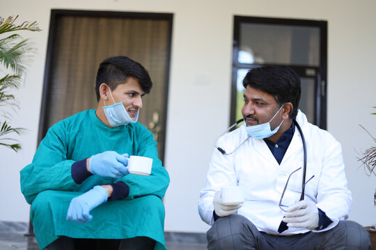 Shallow Focus Of Health Workers Taking A Coffee Break From A Toxic Day At Work