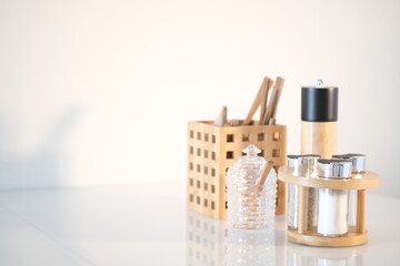 Kitchen utensils background with copyspace, home kitchen decor concept, kitchen tools, wooden accessories in container. Restaurant, cooking, culinary, kitchen theme