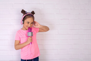 Little girl with a microphone Children dream.