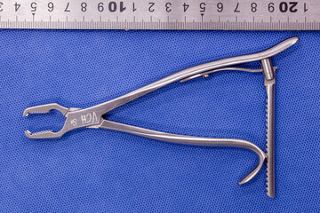 Kern bone holding forceps on a blue background