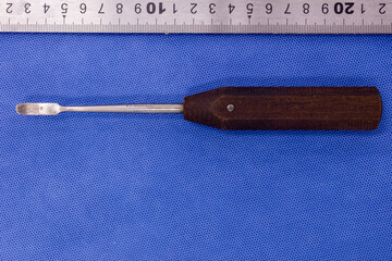 Periosteal elevator on a blue background