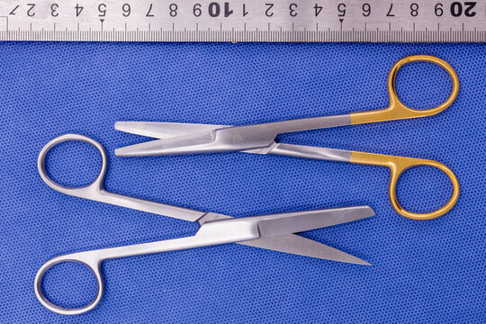 Operating (suture) Scissors On A Blue Background