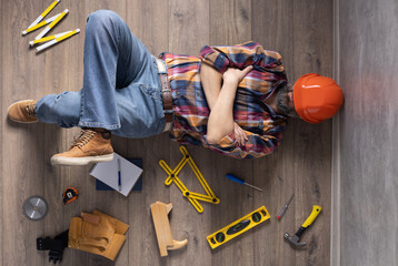 Man worker lying on floor thinking idea solutions. Designer man planning or relaxing