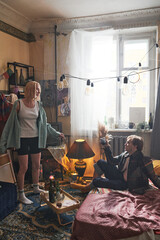 Young couple arranging the party with alcohol drinks in the room at home