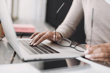 Female hands typing on computer keyboard closeup, business woman or student using laptop at home, online learning, internet marketing, working from home, office workplace, freelance concept