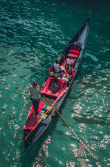 Venetian gondola, Scenic canal ride in colorful channel, top tourist summer activity in Venice, Italy © Markus