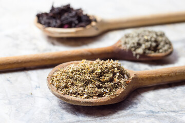 Flower and herbal tea, composition with wooden spoons, sage and cistus