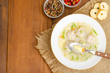 White plate of meatball soup. Studio Photo