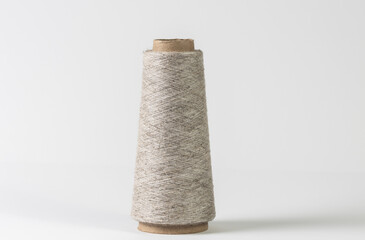 Linen spool of thread on a white isolated background. Textile and design concept