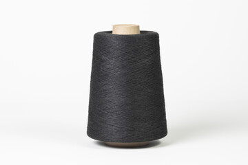 Large spool of thread, black, close-up. Isolated on white background