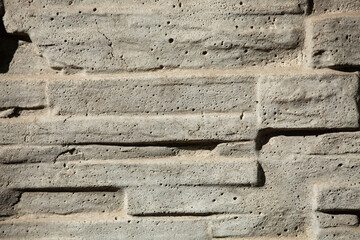 a fragment of a gray figured concrete wall