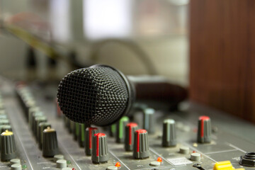 Recording studio mixing room with wireless microphones on a mixer control table.