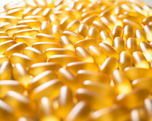 Close-up of golden omega three capsules. Dietary supplement fish oil