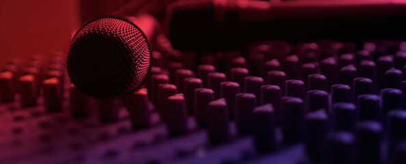 Recording studio mixing room with wireless microphones on a mixer control table.