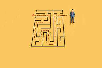 small businessman with maze riddle solving, solving algorithm to find path to goal of business
