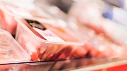 Meat products put up for sale in a supermarket commercial fridge