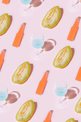 Pattern made with melon,bottles and cocktails against pastel pink background.Minimal summer concept of sunny day.