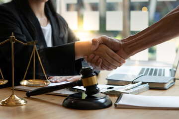 Businessman shaking hands to seal a deal with his partner lawyers or attorneys discussing a contract agreement.Legal law, advice, and justice concept.