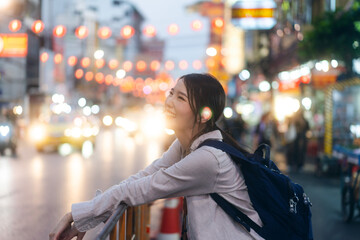 Young adult asian woman traveller backpack traveling in city lifestyle chinatown street food  with bokeh background.