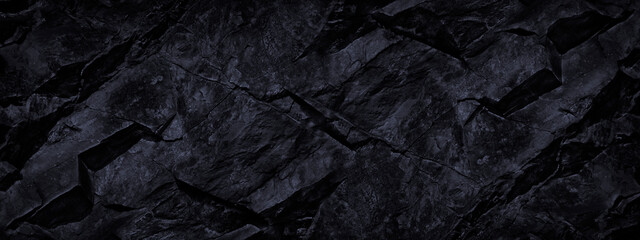 Black rock texture. Dark stone background with copy space for design. Wide banner.