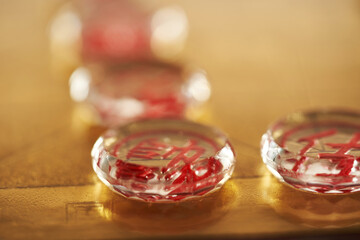 glass pieces of chinese chess on the gold colored chess board