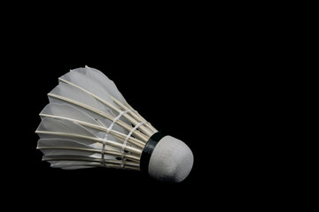 Fototapeta na wymiar Badminton Shutter Cock isolated on Black Background. Healthy lifestyle and sport concept.