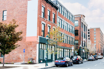 Renovated old apartment buildings with shops on the goung level along a street in a historic...
