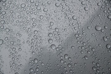 Water drops on car paint. Hydrophobic water effect on car body.