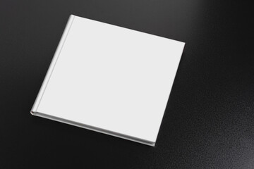 Book with a blank cover on a dark glossy table, editable mock-up series ready for your design
