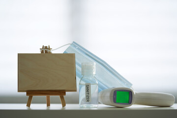 blank  sign with face mask hand sanitizer and thermometer, sop during the pandemic.