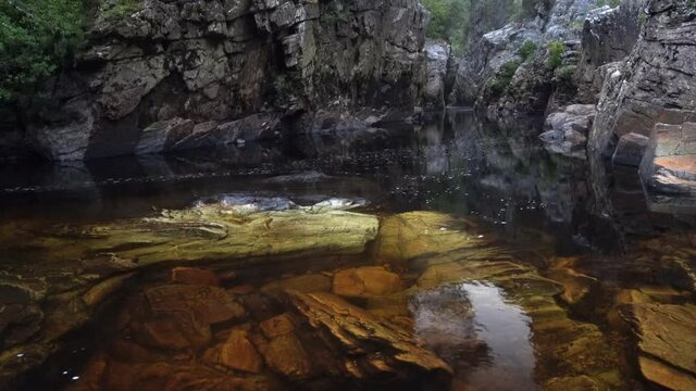 Time-lapse of still waters beneath quartzite walls of The Irenabyss, The Franklin River. Tasmania, Australia. World Heritage Area (WHA). Southwest Wilderness.