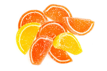Orange and yellow slices of sweet fruit marmalade in sugar isolated on white background