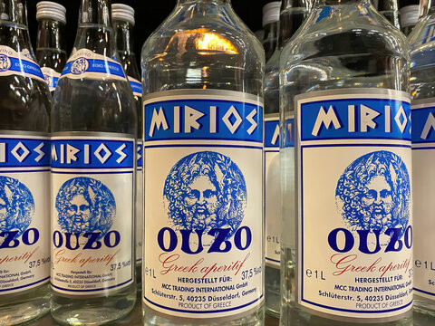 Viersen, Germany - March 1. 2021: Closeup of bottles with logo lettering of mirios greek ouzo in shelf of german supermarket