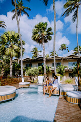Aruba Caribbean couple man and woman mid age on vacation on the beach with palm trees on the beach