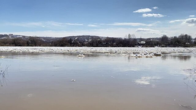 The movement of ice floes on the river during an ice drift in the spring.